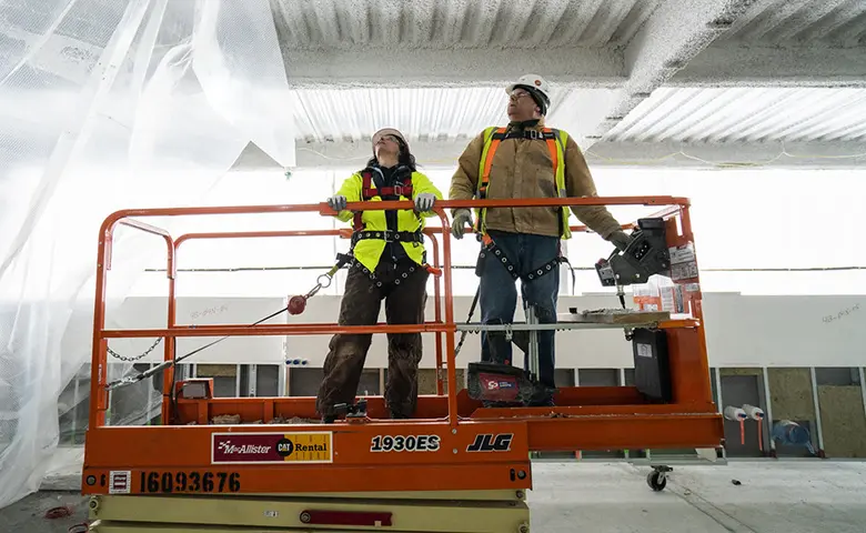 Workers operating a life